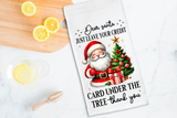Card with Santa Claus illustration and humorous text on a kitchen counter with lemons.