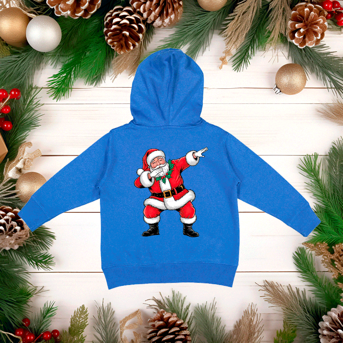Blue hoodie with a cartoon Santa Claus design on a wooden background with Christmas decorations.