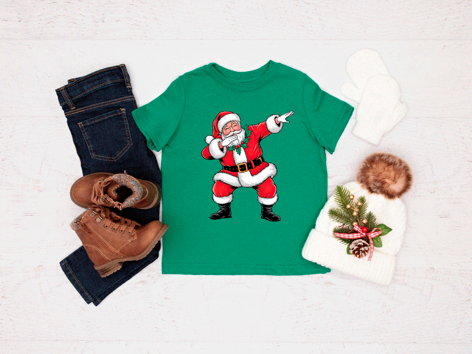 Green t-shirt with a Santa Claus graphic, paired with jeans, boots, and a hat on a light gray background.