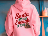 Pink hoodie with humorous text and emoji design on a blue wall background