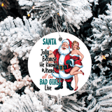 Christmas ornament with Santa and a woman on a snowy tree background