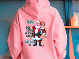 Pink hoodie with a graphic of Santa Claus and a woman, text, and a blue background.