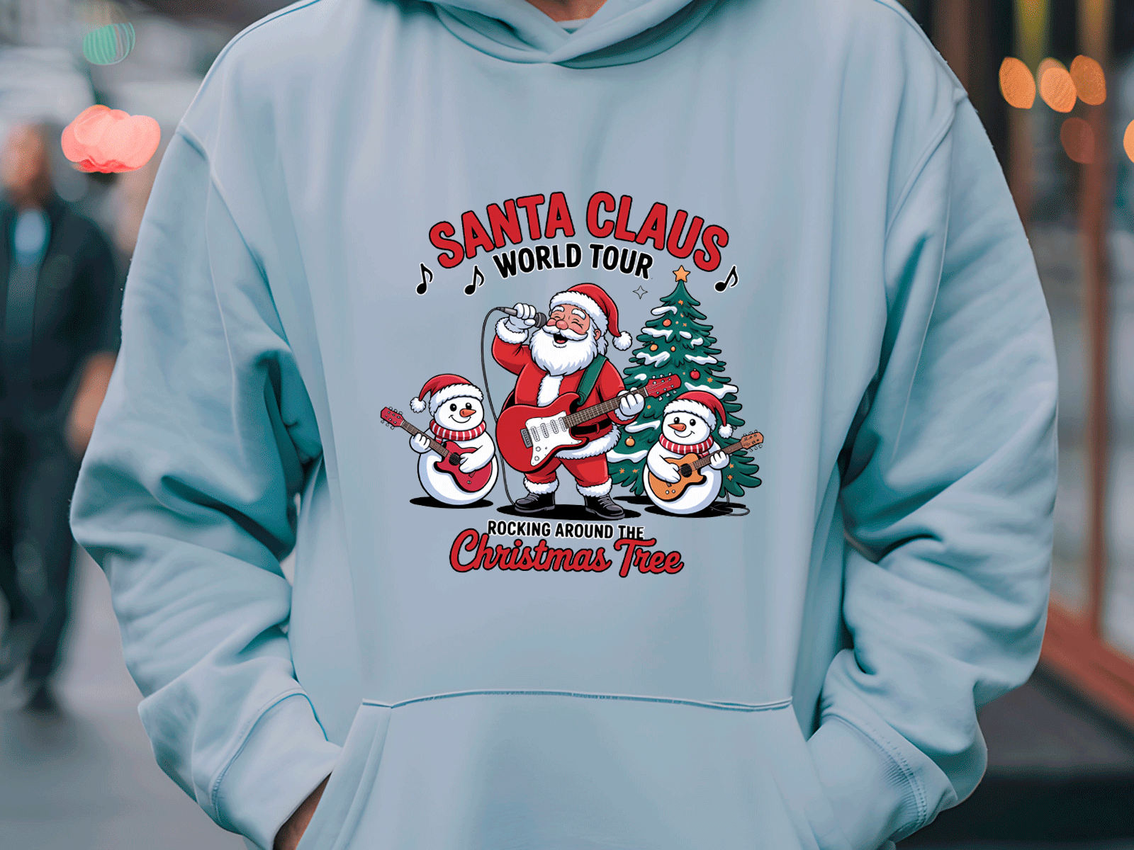 Light blue hoodie with Santa Claus and snowman design on a blurred street background