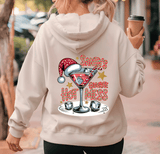 Person wearing a hoodie with a Christmas-themed design of a martini glass and text, holding a coffee cup.