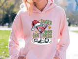 Person wearing a pink hoodie with a Christmas-themed design outdoors.