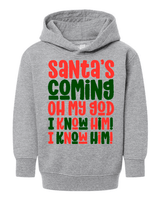 Gray hoodie with colorful text 'Santa's Coming Oh My God I Know Him! I Know Him!' on a white background