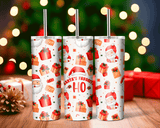 Three Christmas-themed tumblers with Santa Claus and presents on a blurred festive background.