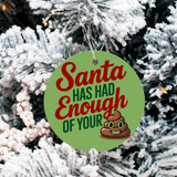 Christmas ornament with text 'Santa has had enough of your poop' on a snowy tree background