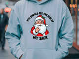 Light blue hoodie with a graphic of Santa Claus and text on a blurred street background