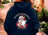 Navy blue hoodie with a graphic of Santa Claus and text on the back, worn by a person.