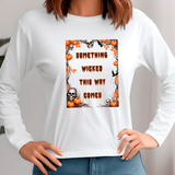White sweatshirt with Halloween-themed design and text 'Something Wicked This Way Comes' on a plain background.