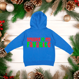 Blue hoodie with 'SMILING IS MY FAVORITE' text on a wooden surface with Christmas decorations.