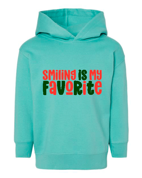 Turquoise hoodie with 'Smiling is my favorite' text in red and green on a white background
