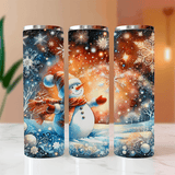Three tumblers with winter-themed designs featuring snowmen and snowflakes on a light surface.