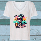 White t-shirt with a colorful skeleton design and 'Spooky Mama' text on a wooden background