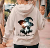 Person wearing a hoodie with a witch graphic and text 'Stay Wild Moon Child' on the back.