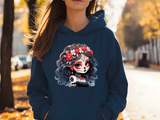 Person wearing a navy blue hoodie with a colorful skull design outdoors.