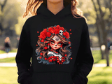 Person wearing a black hoodie with a colorful design of a face with flowers and skulls.