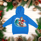 Blue hoodie with a Santa Claus surfing design on a wooden background with Christmas decorations.