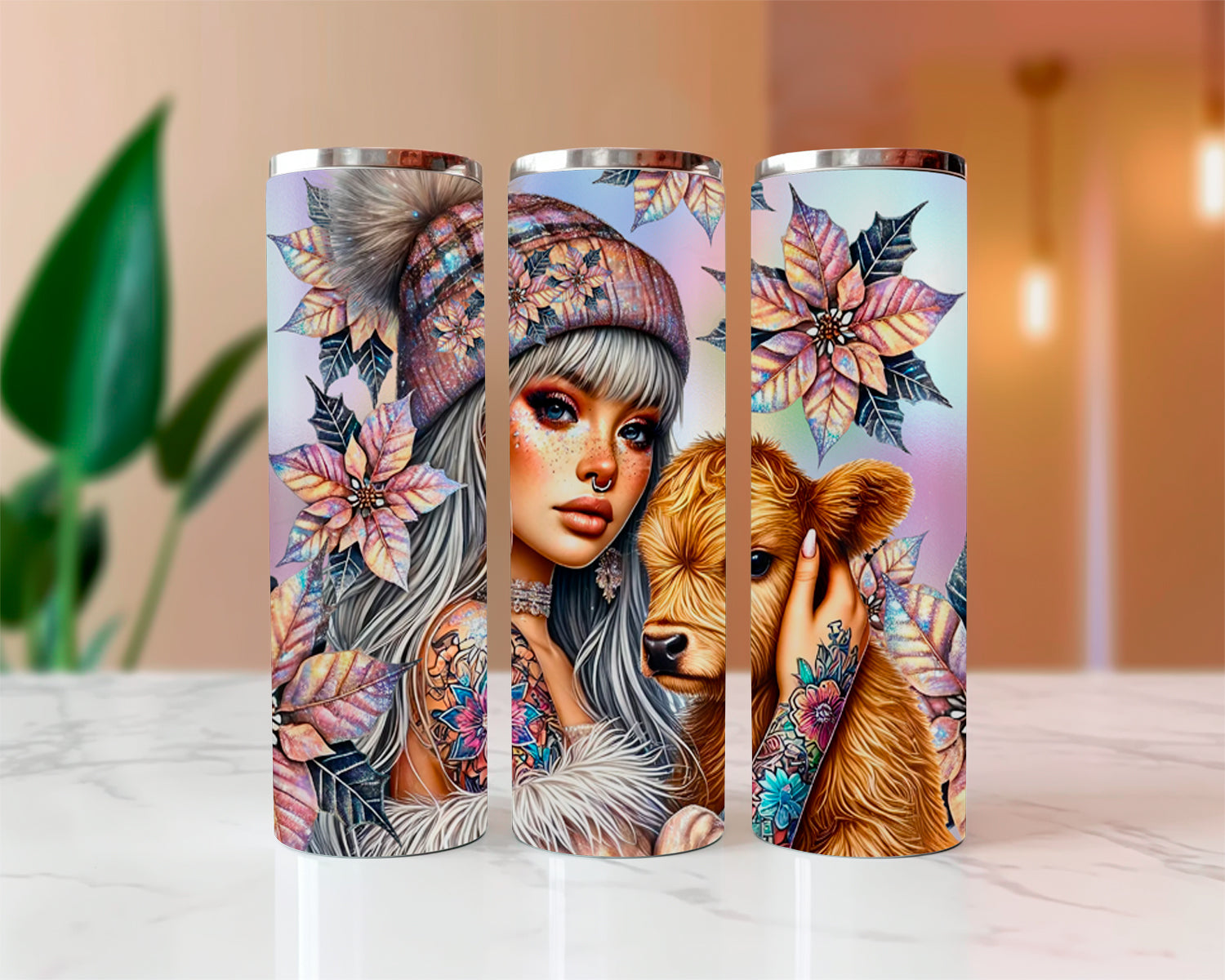 Three tumblers with artistic designs of a woman, flowers, and a bear on a white surface.