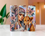 Three tumblers with artistic designs of a woman, flowers, and a bear on a white surface.