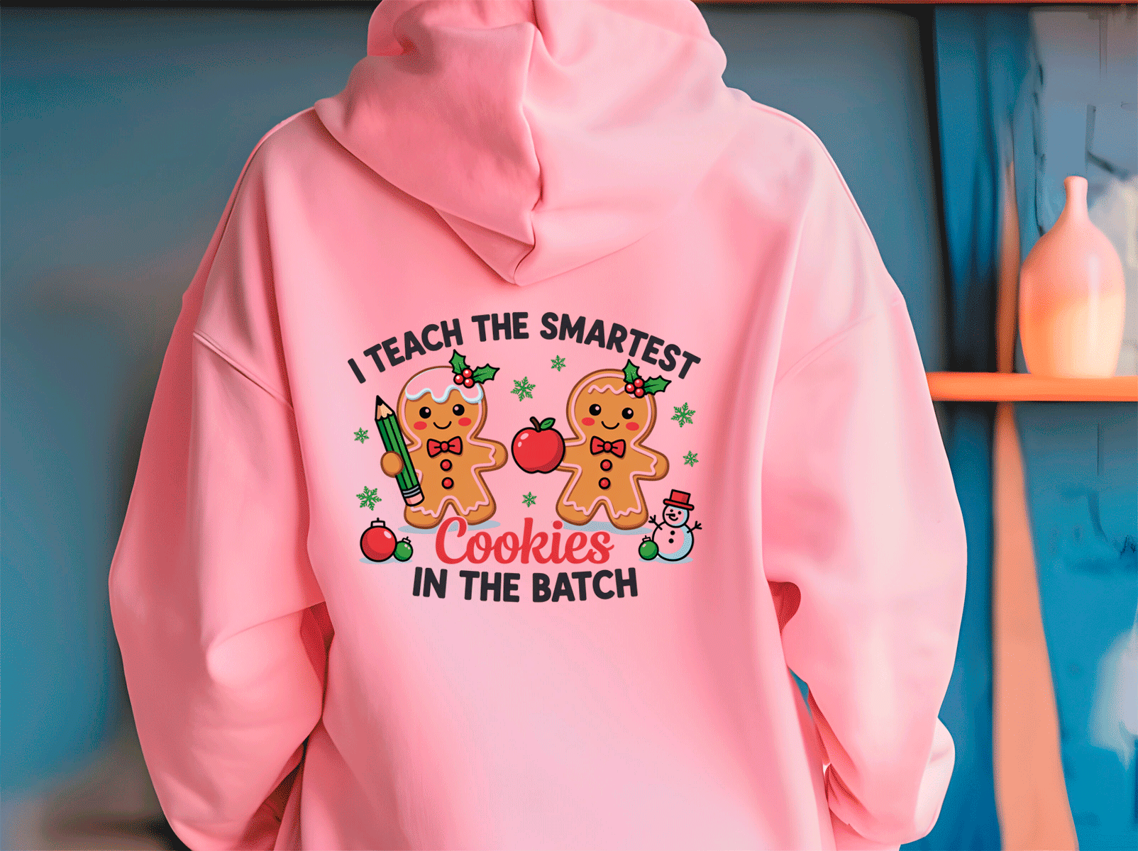 Pink hoodie with a humorous design of gingerbread men and text on a blue background