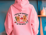 Pink hoodie with a humorous design of gingerbread men and text on a blue background