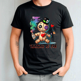 Person wearing a black t-shirt with a cartoon character and text 'Thinking of You' on a plain background