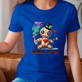 Person wearing a blue t-shirt with a cartoon character and text 'Thinking of You'.