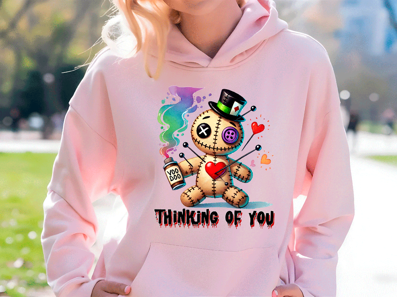 Person wearing a pink hoodie with a cartoon character and 'Thinking of You' text.