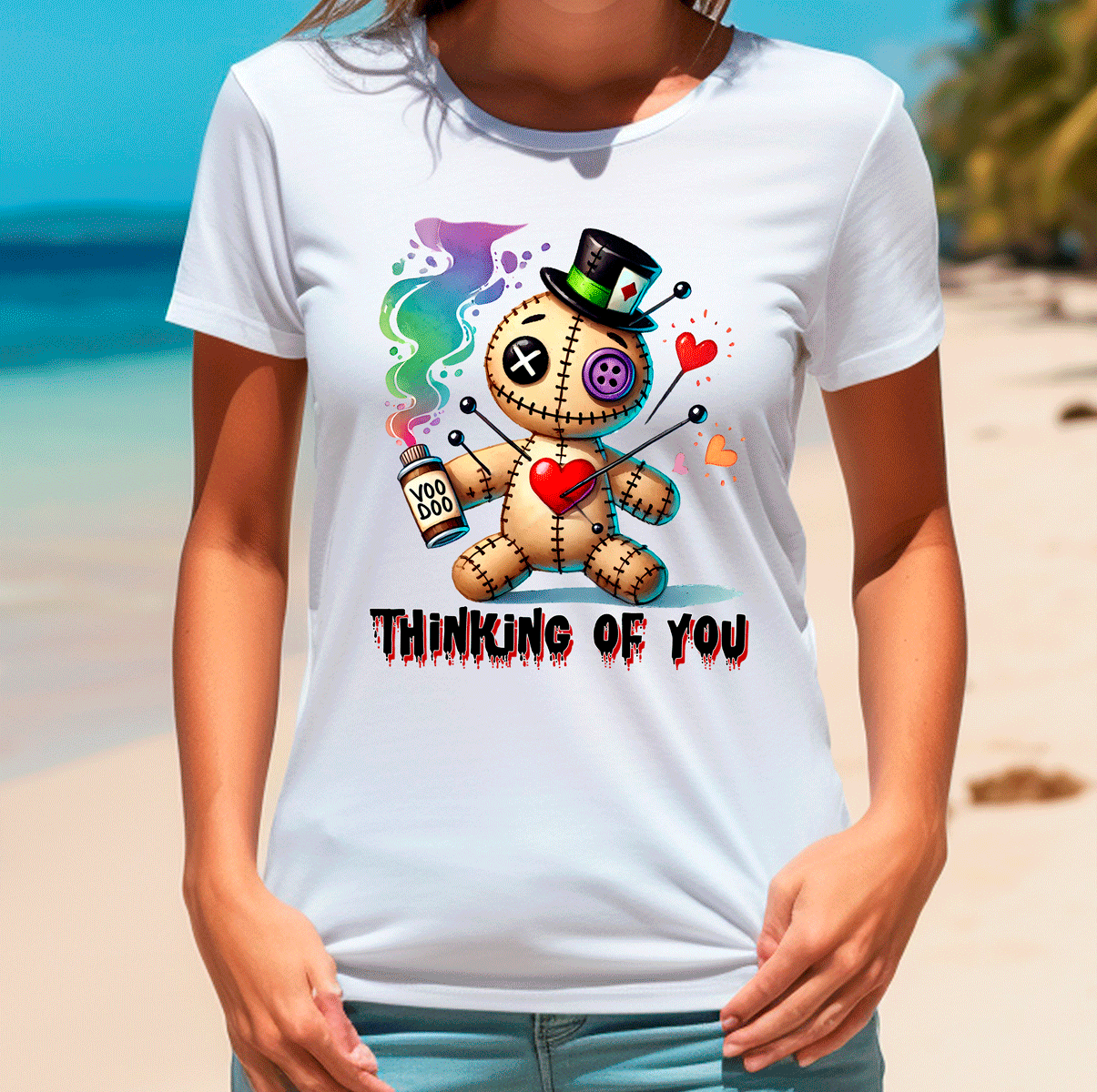 Person wearing a white t-shirt with a colorful graphic design on a beach.