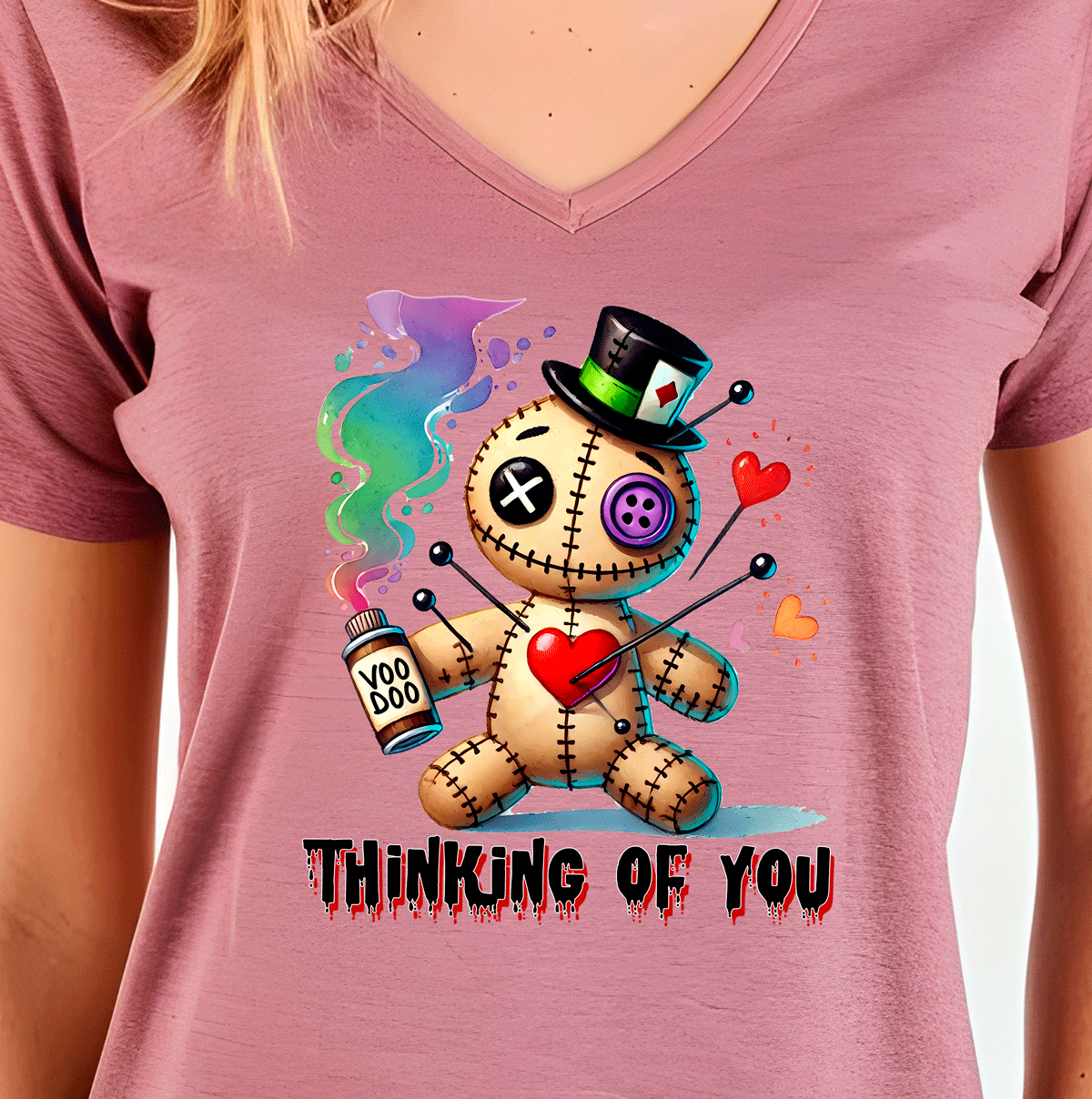 Pink t-shirt with a cartoon voodoo doll design and 'Thinking of You' text.