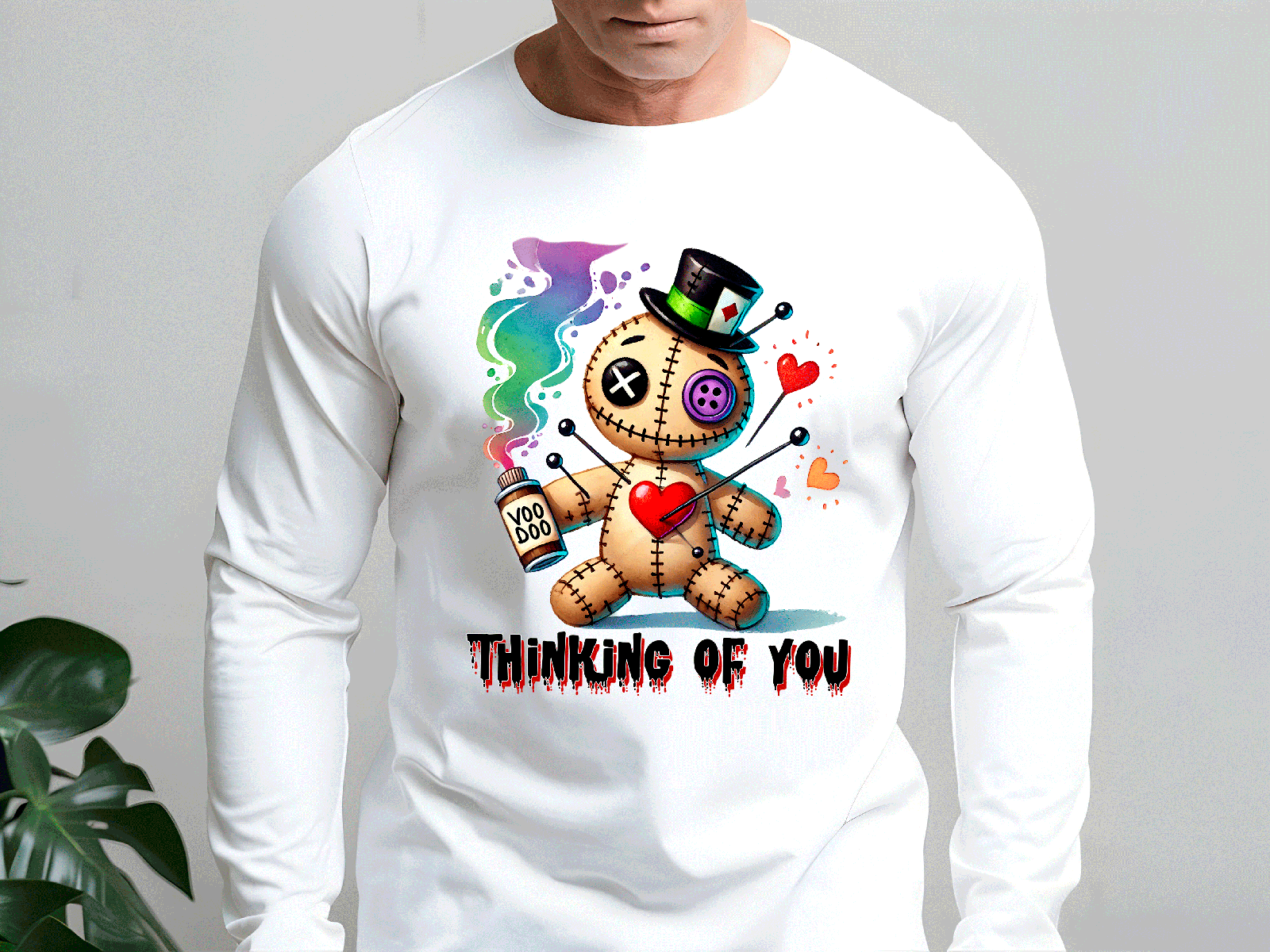 White long-sleeve shirt with a colorful graphic of a voodoo doll and 'Thinking of You' text.