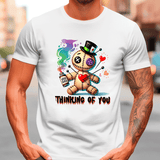 White t-shirt with a colorful graphic design of a teddy bear and text 'Thinking of You' worn by a person.