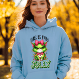 Person wearing a blue hoodie with a festive design in an autumn setting
