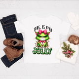 T-shirt with Grinch design and text 'This is my Jolly' on a white background with jeans, boots, and a hat.