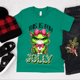 Green t-shirt with Christmas-themed design featuring a cat, surrounded by festive items on a white background.