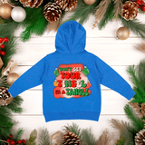 Blue hoodie with festive text on a wooden background with Christmas decorations