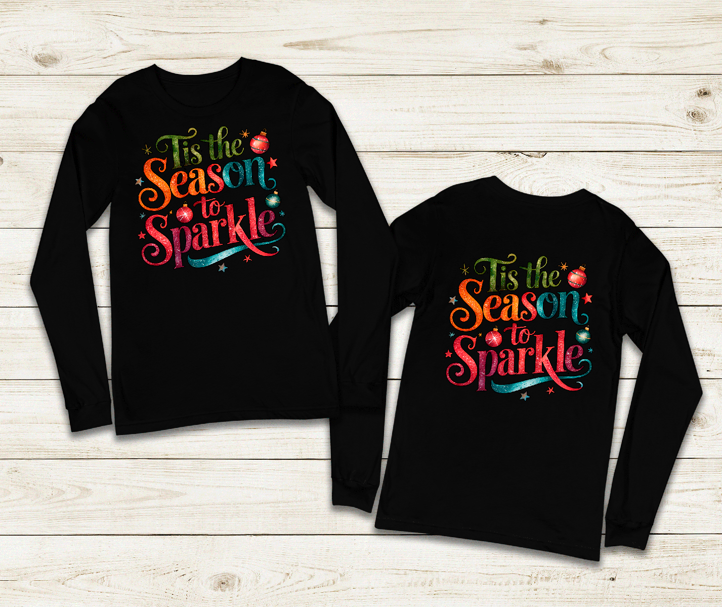 Black long-sleeve shirts with colorful text design on a wooden surface