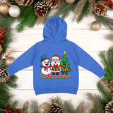 Blue hoodie with Christmas-themed design on a wooden surface with holiday decorations.