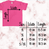 Pink t-shirt with size chart on a marble background