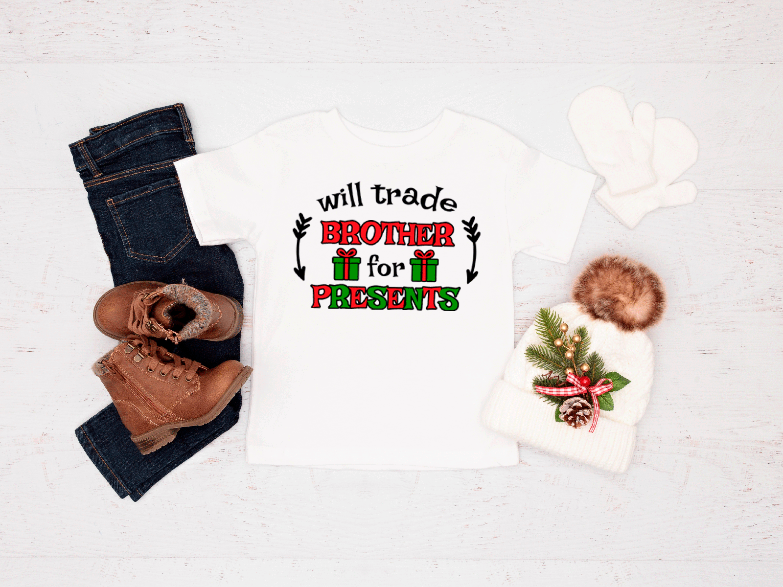 T-shirt with Christmas design, jeans, boots, and baby outfit on a white background