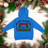 Blue hoodie with Christmas-themed text on a wooden background with festive decorations