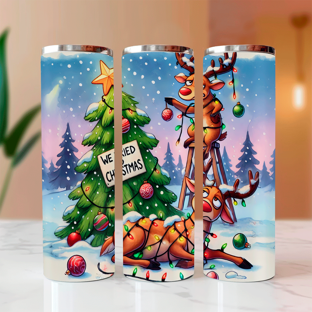 Three cylindrical tumbler designs featuring Christmas-themed illustrations of reindeer and a tree.
