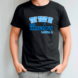 Person wearing a black t-shirt with blue text against a light gray background