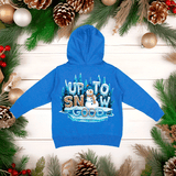 Blue hoodie with 'Up to Snow Good' text and snowman graphic on a wooden background with Christmas decorations.
