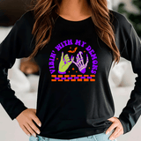 Black sweatshirt with colorful graphic design and text worn by a person indoors.
