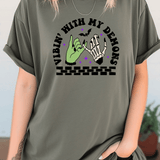 Person wearing a green t-shirt with a graphic design and text.