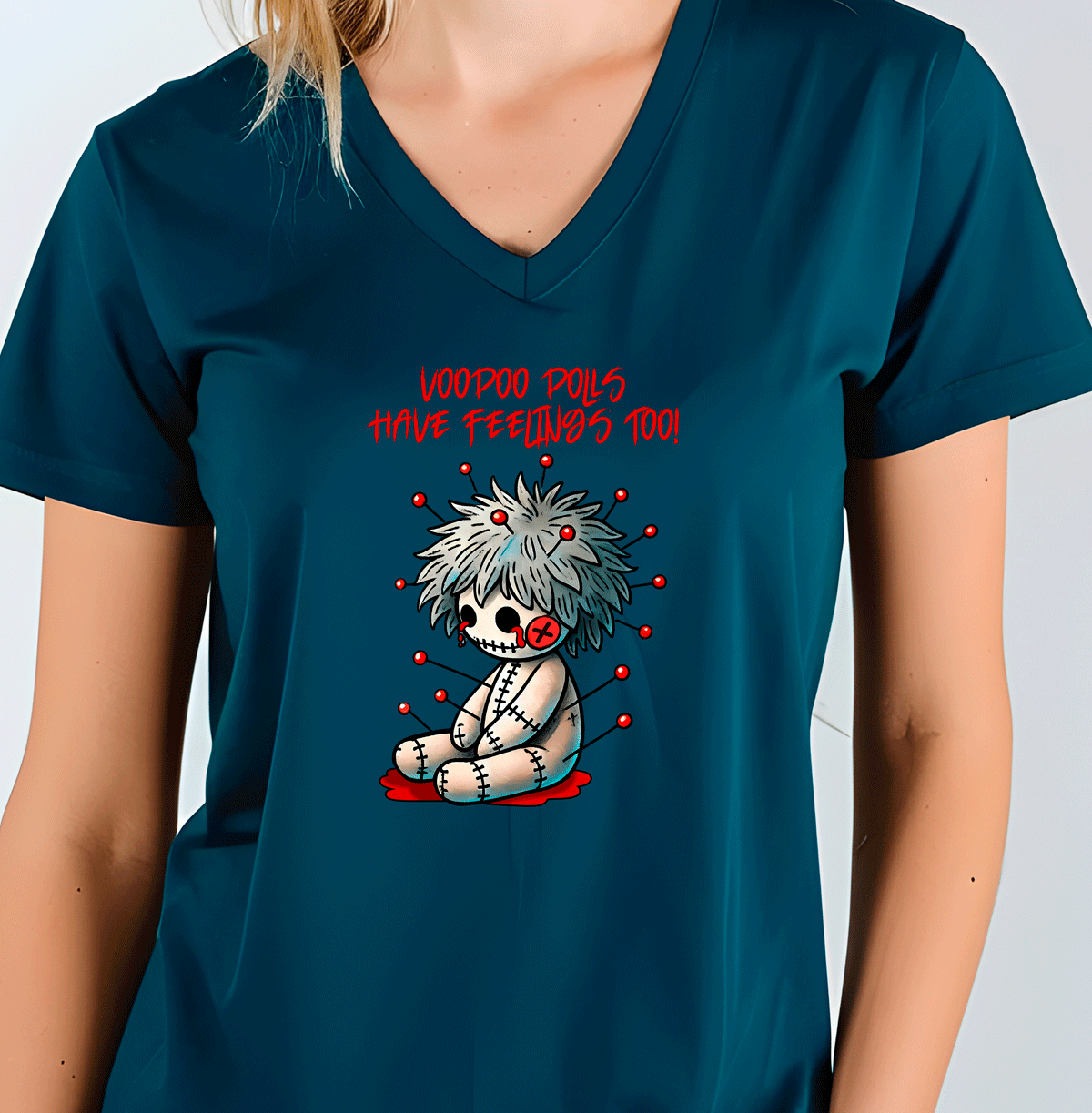 Person wearing a teal t-shirt with a graphic design of a voodoo doll and text.