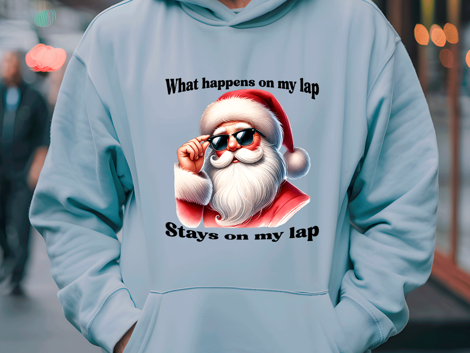 Light blue hoodie with a graphic of Santa Claus and text 'What happens on my lap stays on my lap'.